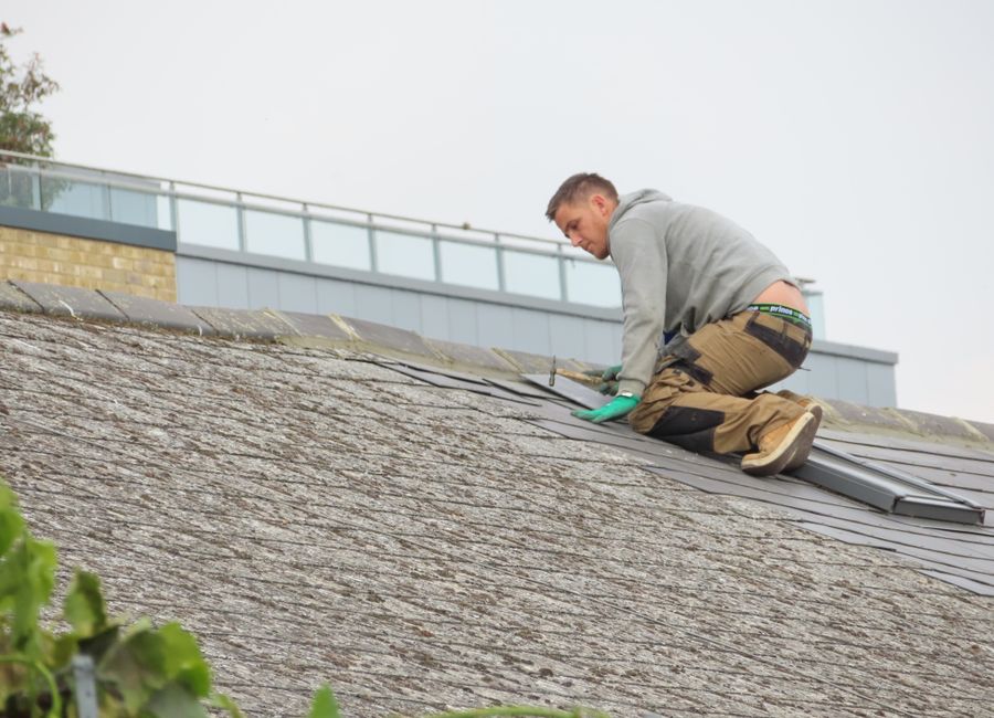 Roofer performing a roof repair